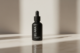 ELARA Ceramide Repair Serum on reflective marble surface